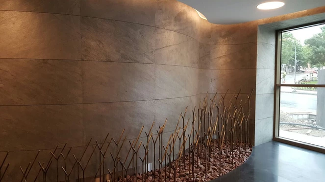 Cobre slate veneer cladding on curved interior feature wall