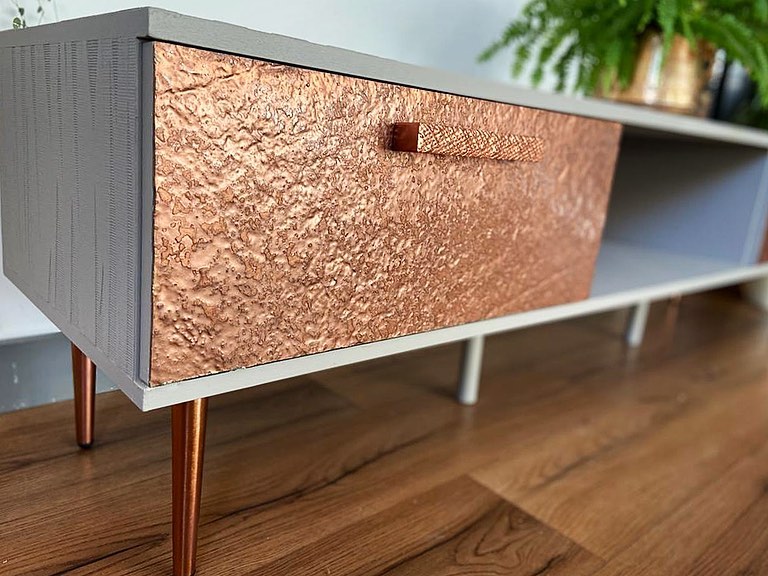 Copper metal veneer cladding on contemporary cabinet