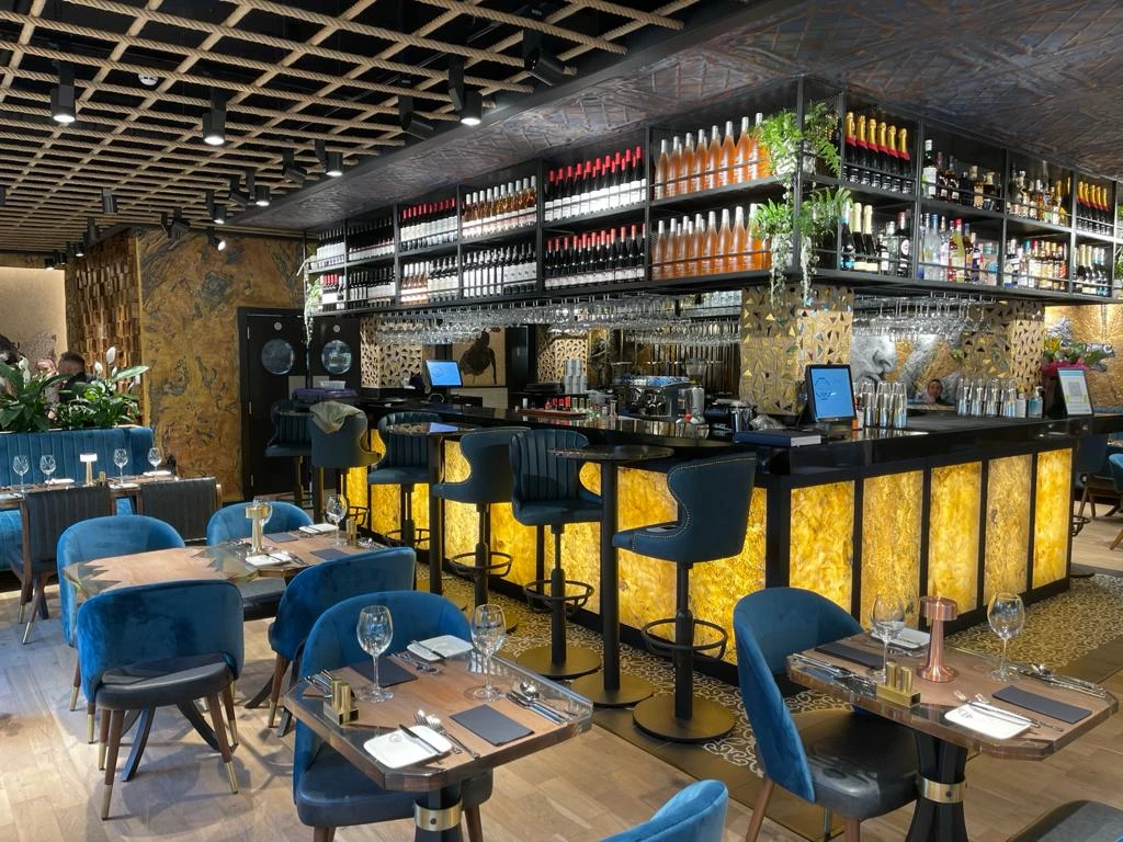 Back-lit Falling Leaves translucent stone veneer restaurant bar.