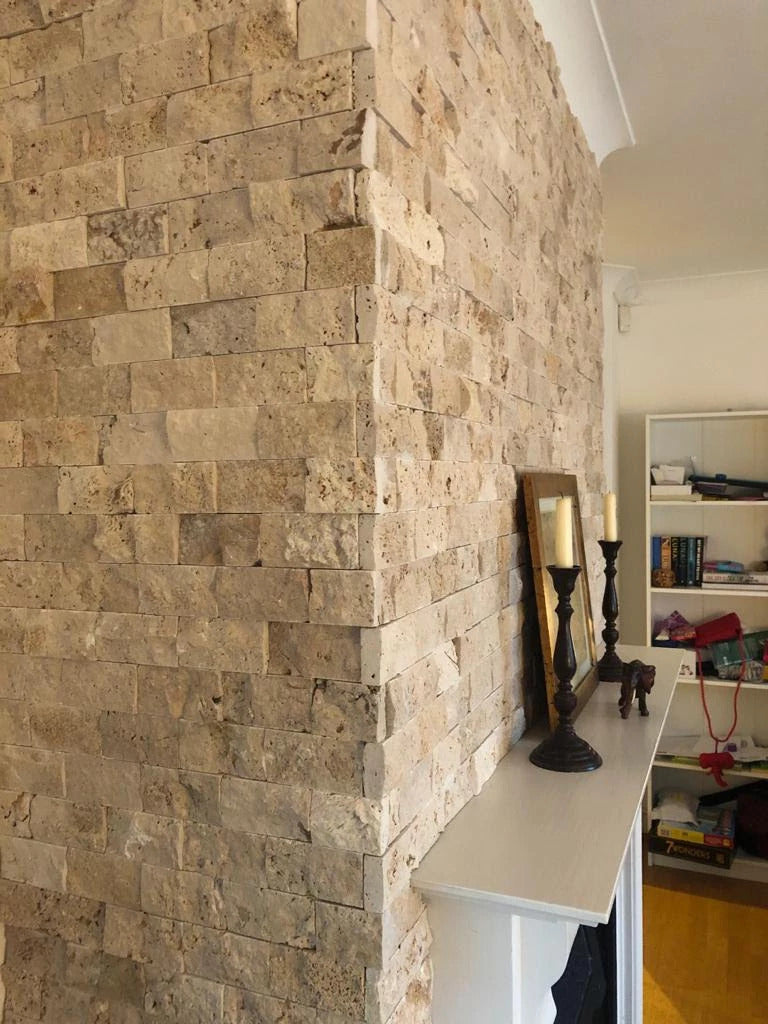 Rustic travertine split face cladding on interior feature wall