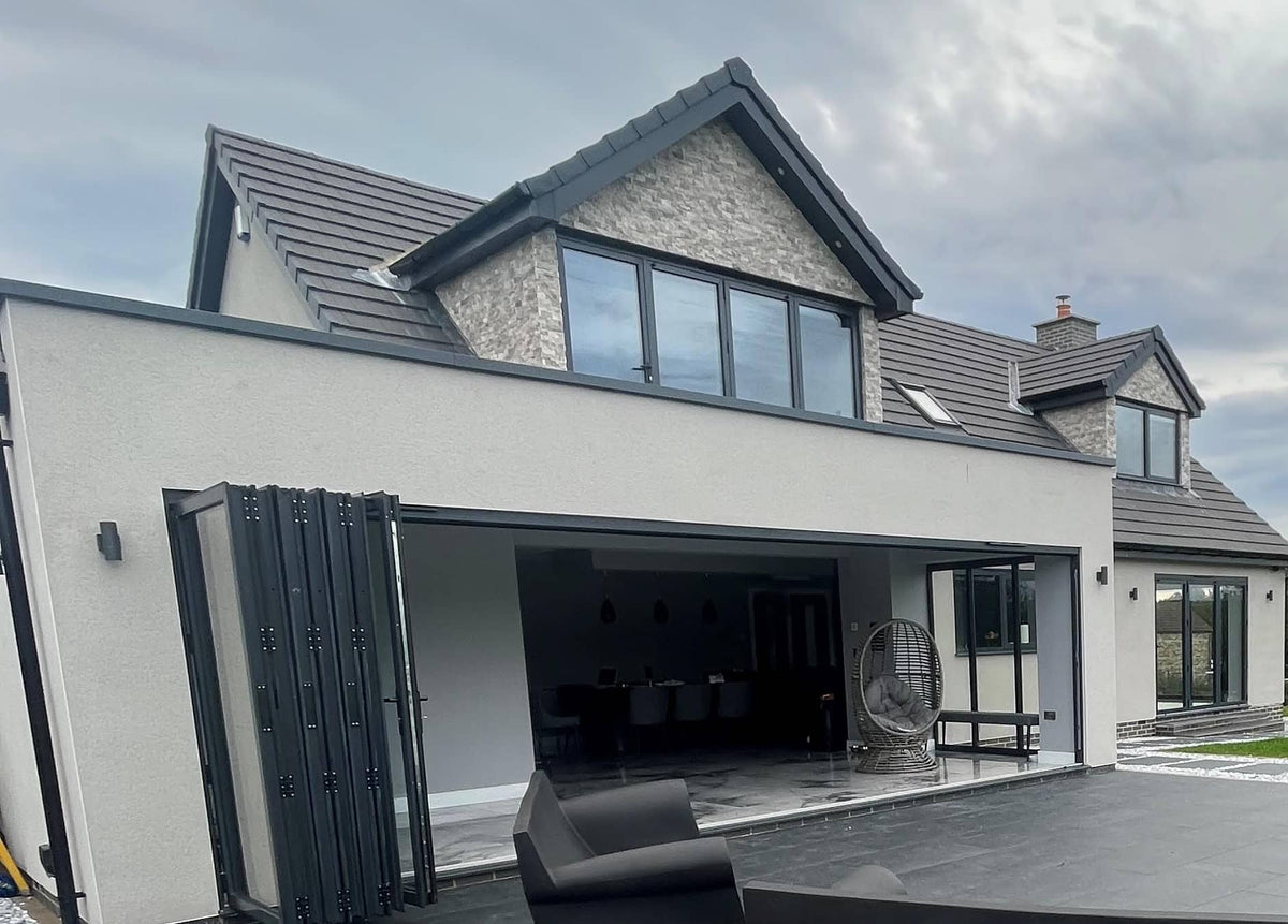 Silver travertine split face cladding on modern house exterior