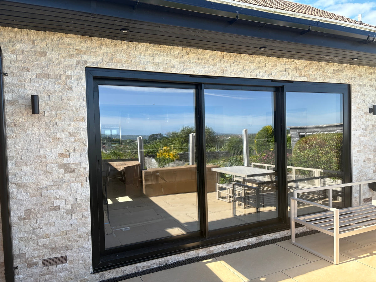 Split face stone cladding around exterior sliding doors