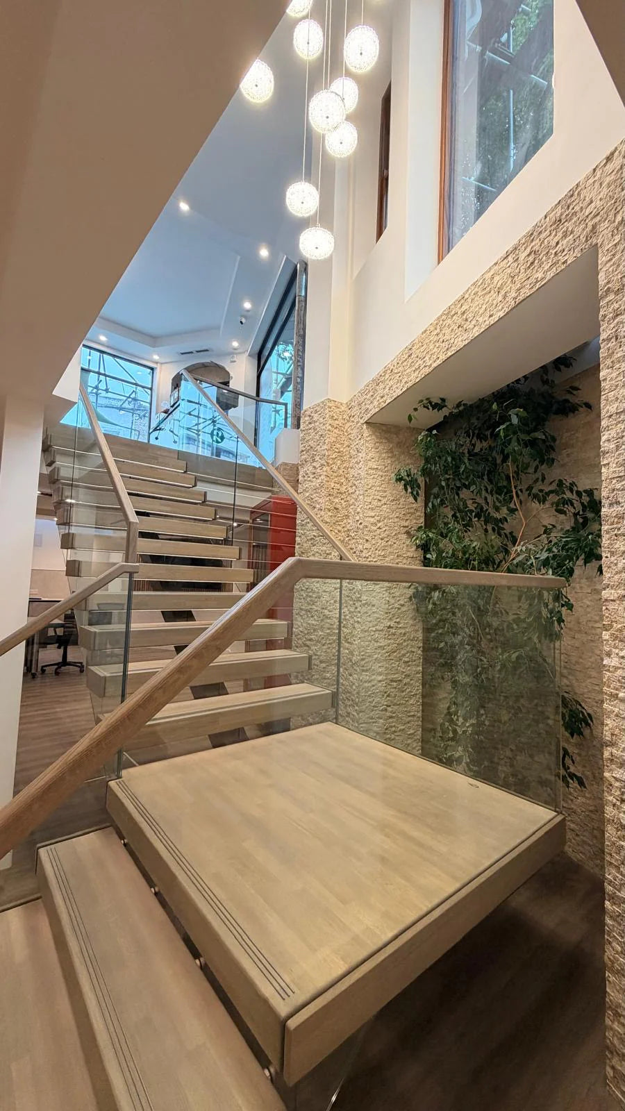 Split face stone cladding on modern staircase feature wall