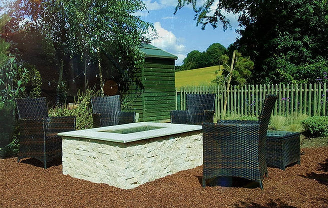Classic Travertine split face cladding on outdoor garden fire pit