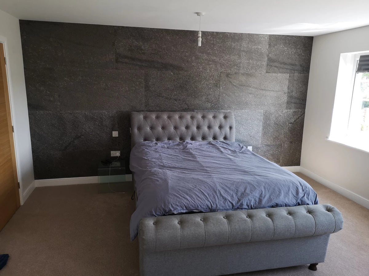 Black Pearl stone veneer feature wall behind bed