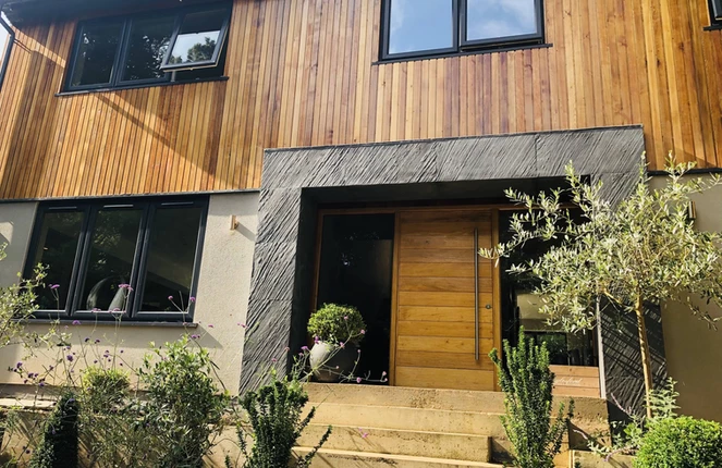 D Black slate veneer exterior cladding around house entrance