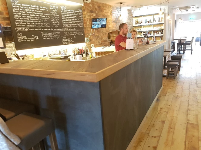 Nero slate veneer cladding on café counter