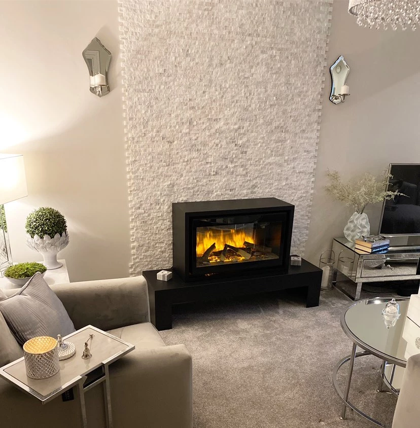White marble split face cladding around living room fireplace
