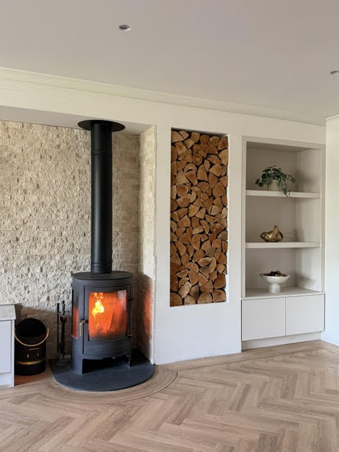 Classic travertine split face cladding behind a log burner.