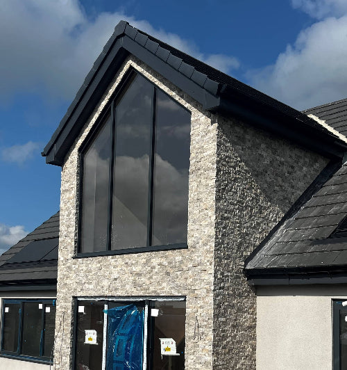 Silver travertine split face cladding on modern house exterior