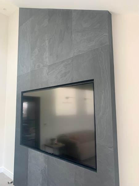 Nero slate veneer media wall around television