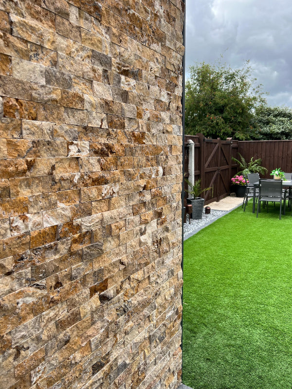 Scabos multicolour travertine split face cladding on garden wall